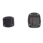 Two small black plastic mounting or attachment pieces shown side by side on a plain white background, with screws visible around the edges.