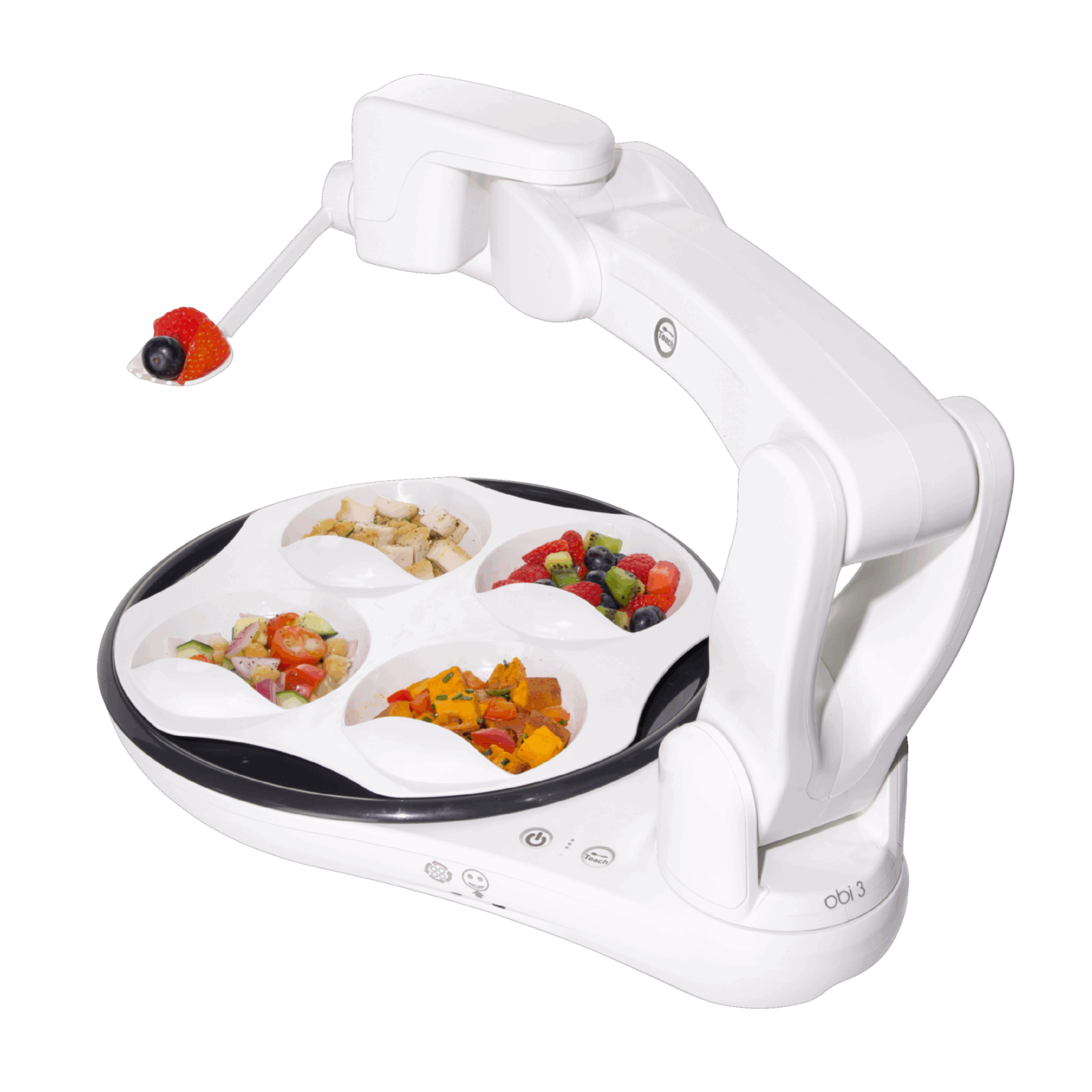 A white robotic food preparation and serving system with a curved arm, a round divided tray holding mixed foods, and a small handheld tool with a red and black head, shown on a black background.