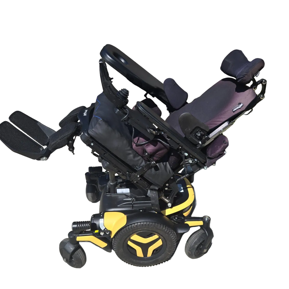 A high-angle studio shot of a power wheelchair against a light blue gradient background. The wheelchair features a black seat and armrests with a purple accent on the headrest, black and yellow frame components, and black wheels with yellow accents.