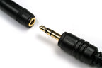 Close-up of a black audio adapter cable with a gold-plated 3.5mm jack connector on a white background.