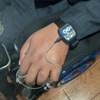 Person using a Kinemo One attached to their hand on a wooden floor.