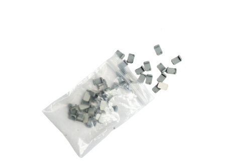 Small rectangular components spilled from a clear plastic bag on a plain white background.