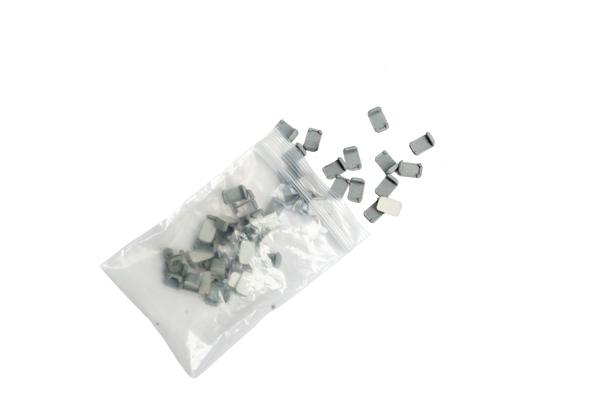 Small rectangular components spilled from a clear plastic bag on a plain white background.